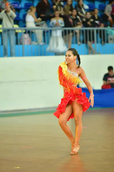 Dancesport competitor: ** Red Latin dress
*   **Color:** Primarily vibrant red