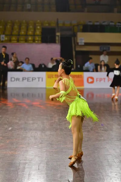 Dancesport competitor: Female dancer: lime green latin dress with fringe