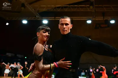 Dancesport competitor: Male dancer: black long-sleeve turtleneck and black trousers