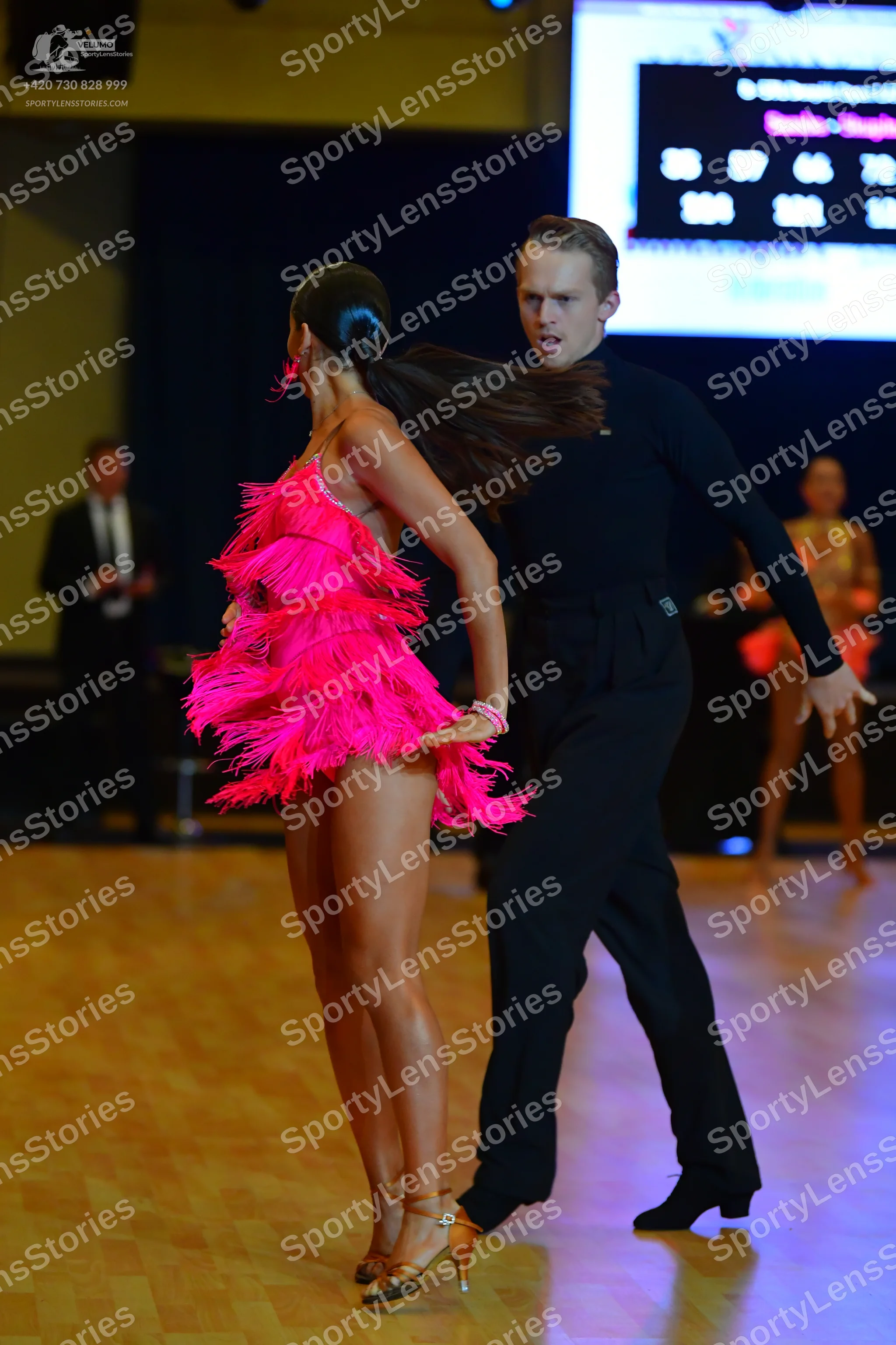 Dancesport competitor: Female dancer: hot pink Latin dress with fringe
