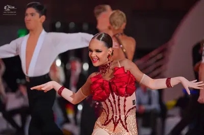 Dancesport competitor: Male dancer: white shirt with a deep V-neck and black trousers