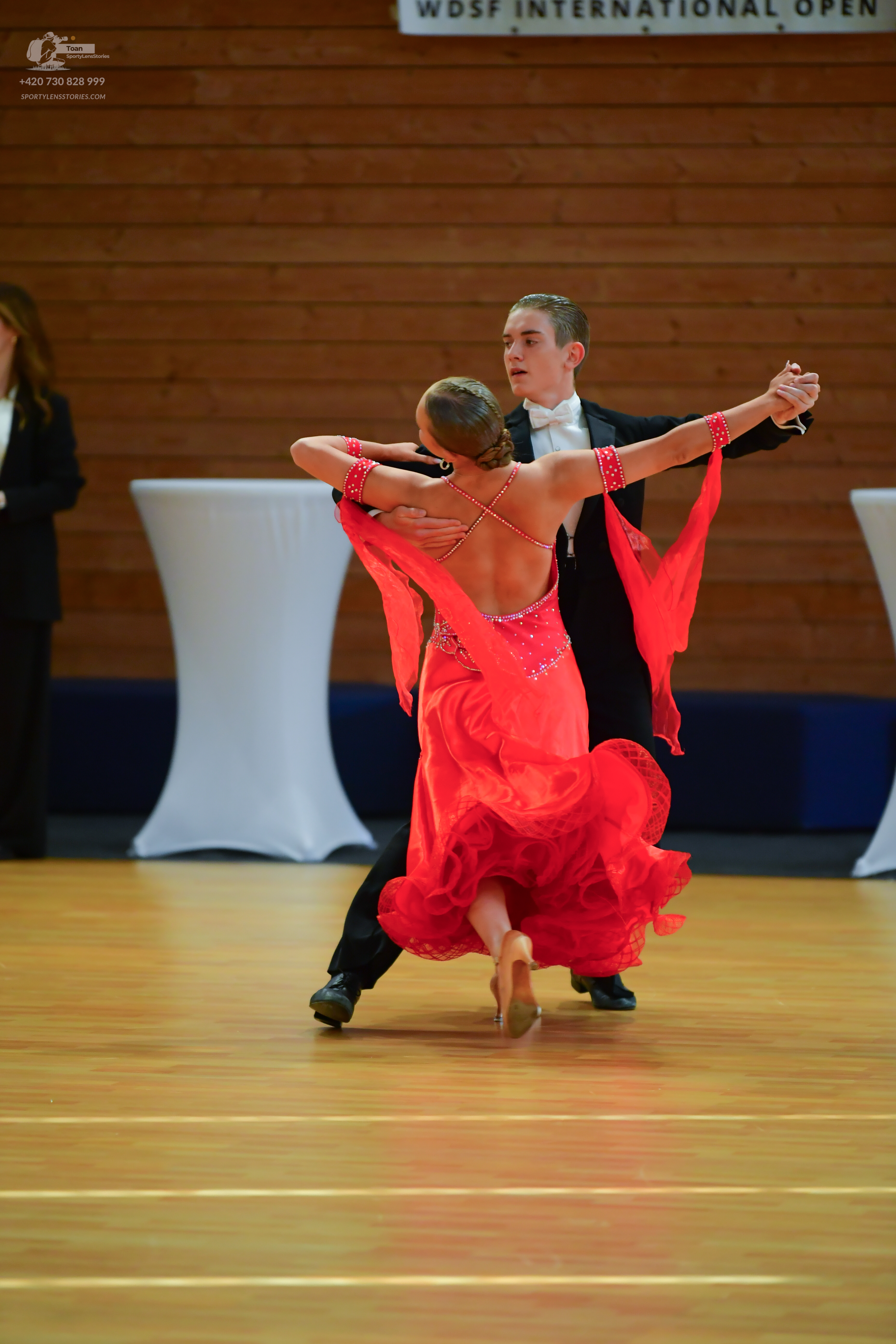Dancesport competitor: Male:** Black tail suit with iridescent sequin lapels