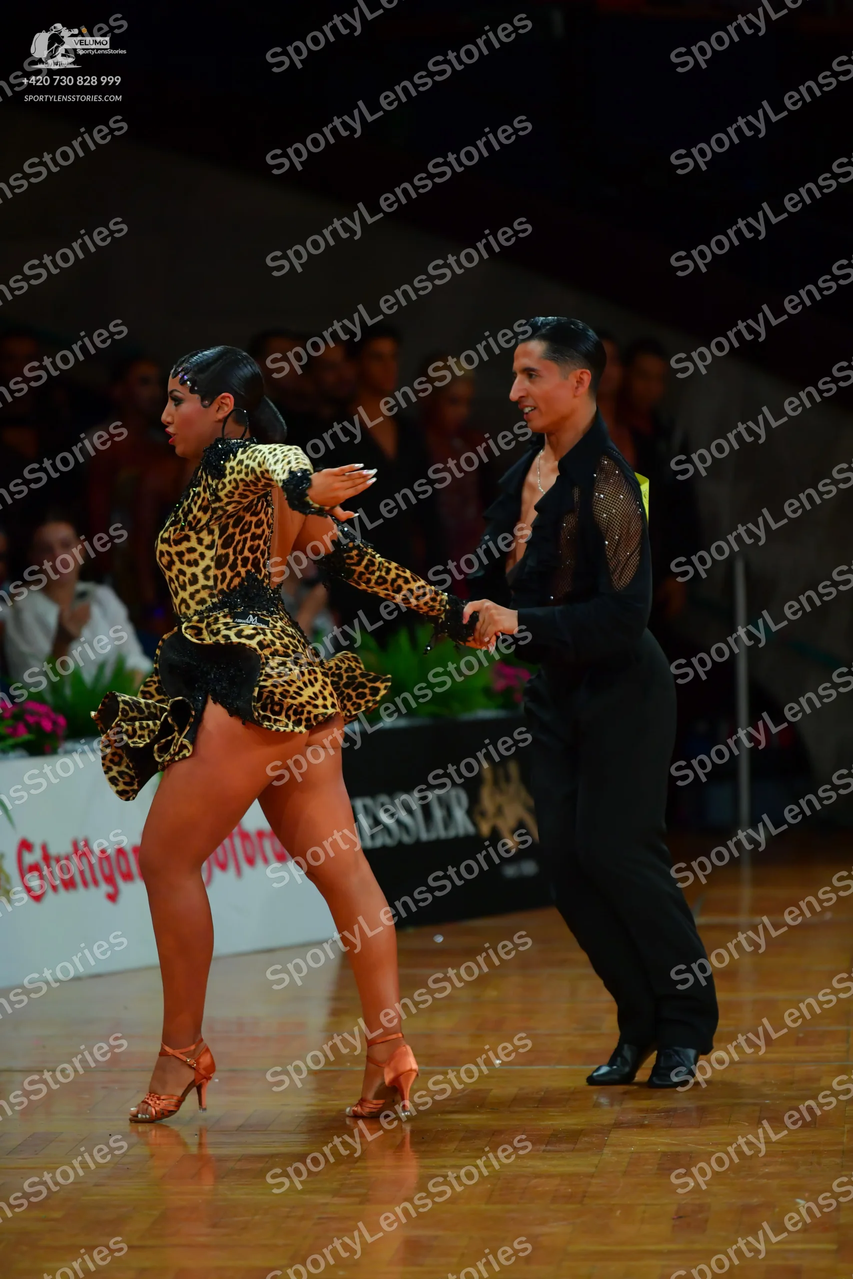 Dancesport competitor: Male dancer: black latin dance shirt with sheer mesh sleeves and subtle sequins,
