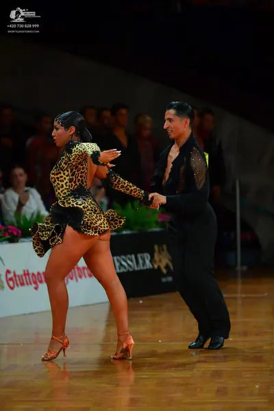 Dancesport competitor: Male dancer: black latin dance shirt with sheer mesh sleeves and subtle sequins,