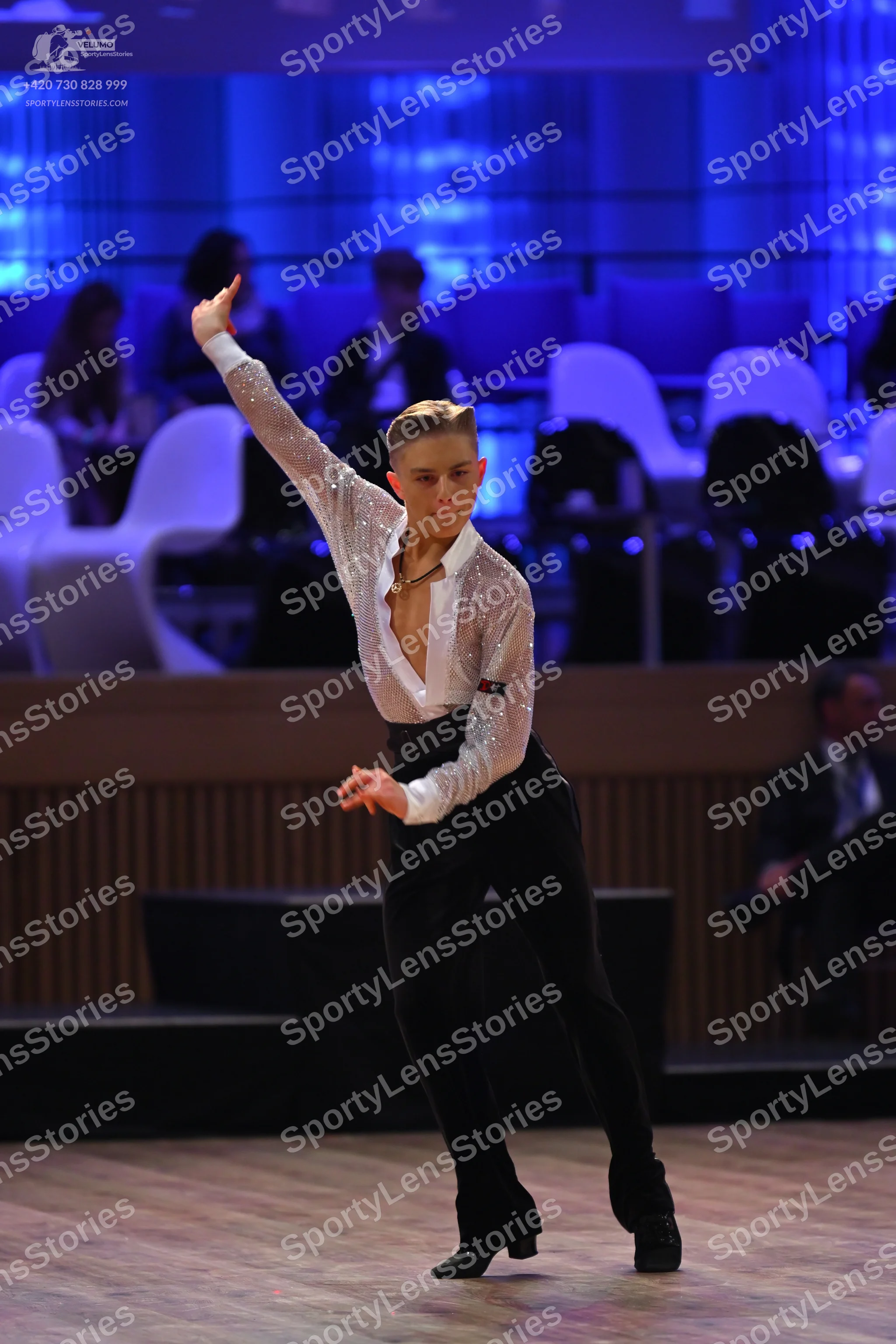 Dancesport competitor: Male dancer: white long-sleeved shirt with subtle sequin shimmer and an open col