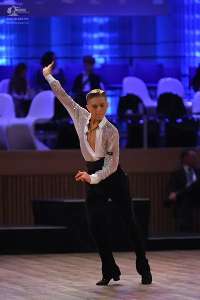 Dancesport competitor: Male dancer: white long-sleeved shirt with subtle sequin shimmer and an open col