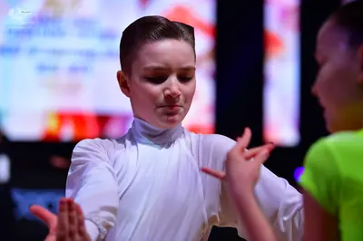 Dancesport competitor: Male dancer: white long-sleeved high-neck top in a smooth, satin-like fabric