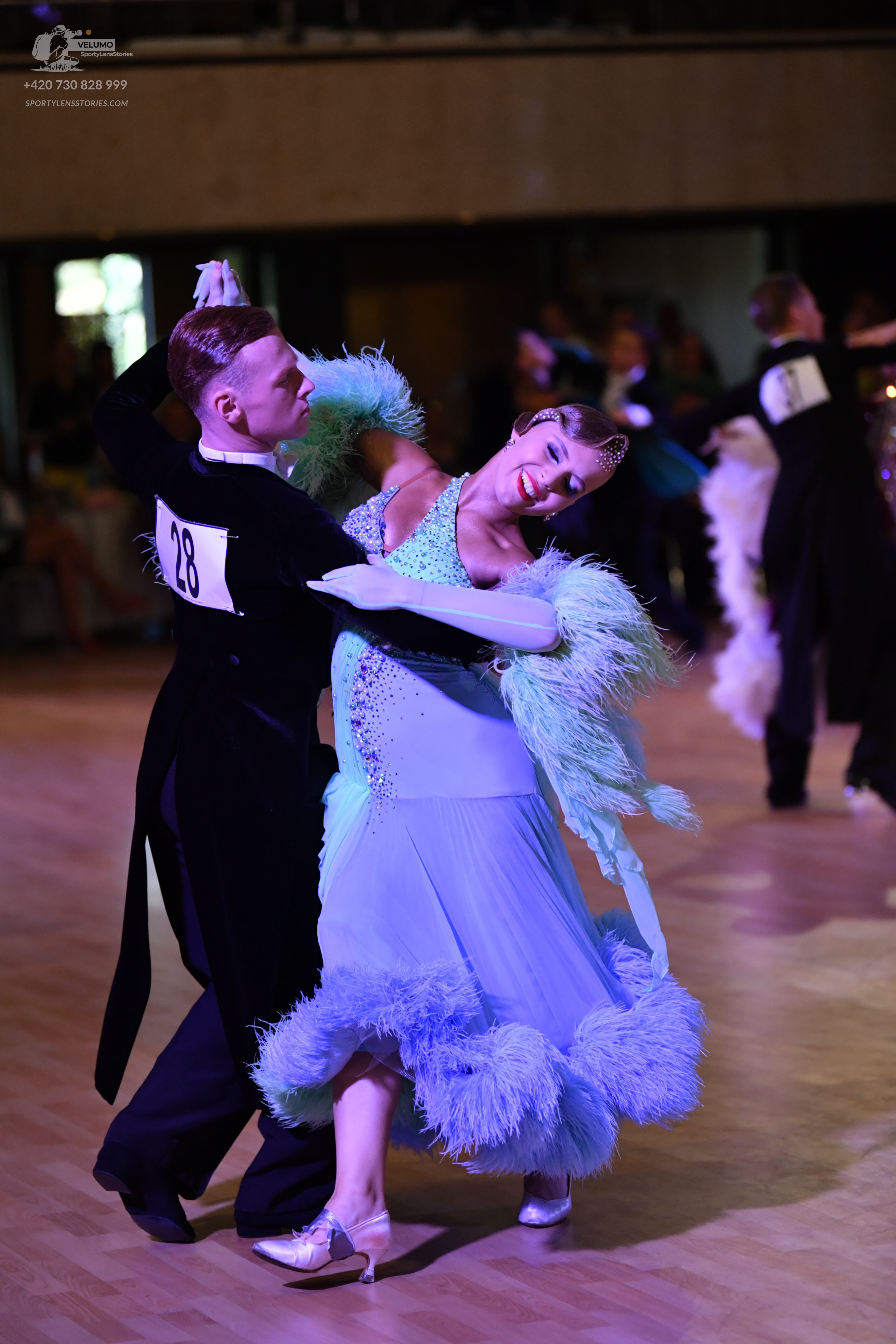 Dancesport competitor: ** Black tail suit
*   **Fabric:** Appears to be a dark, possibly satin or velve