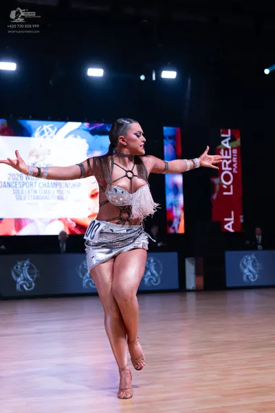 Dancesport competitor: Female dancer: silver latin dress with sequins and white fringe