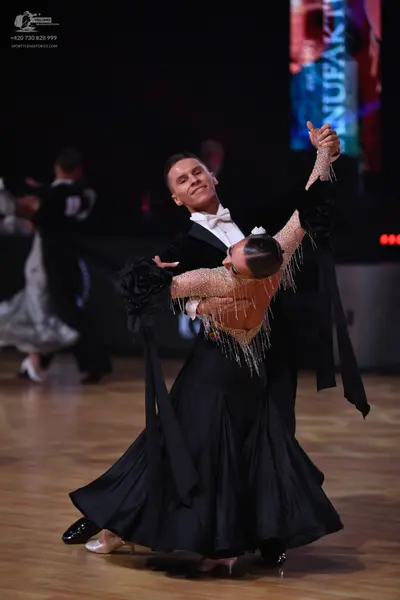 Dancesport competitor: Male dancer: black ballroom tailcoat with a white shirt and white bow tie