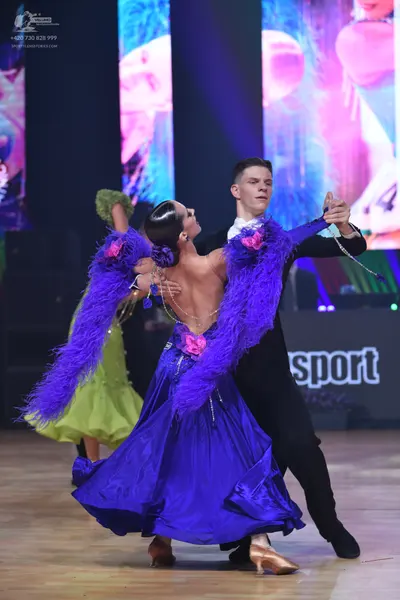 Dancesport competitor: Male dancer: black suit with a white shirt and black bow tie