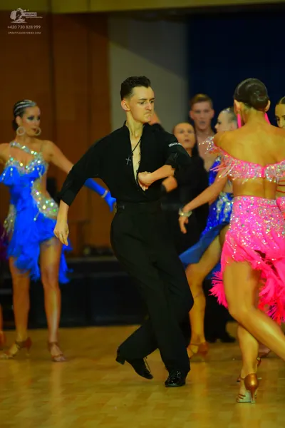 Dancesport competitor: Male dancer: black long-sleeved shirt and black trousers