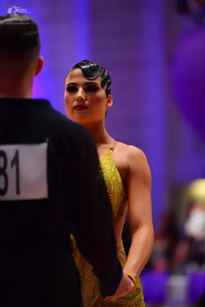 Dancesport competitor: Male dancer: black long-sleeved top