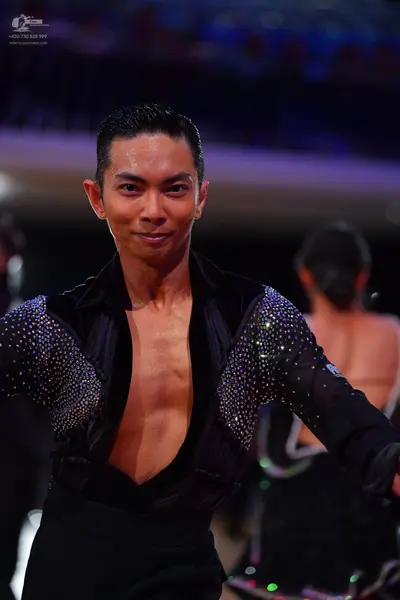 Dancesport competitor: Male dancer: black long-sleeved Latin shirt with large silver sequined panels on