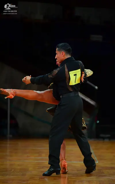 Dancesport competitor: Male dancer: black long-sleeved shirt with black sequin detail on the sleeves an