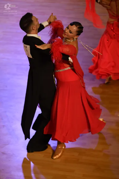 Dancesport competitor: Male:** Black suit with a shimmering sequin lapel and matching shoes