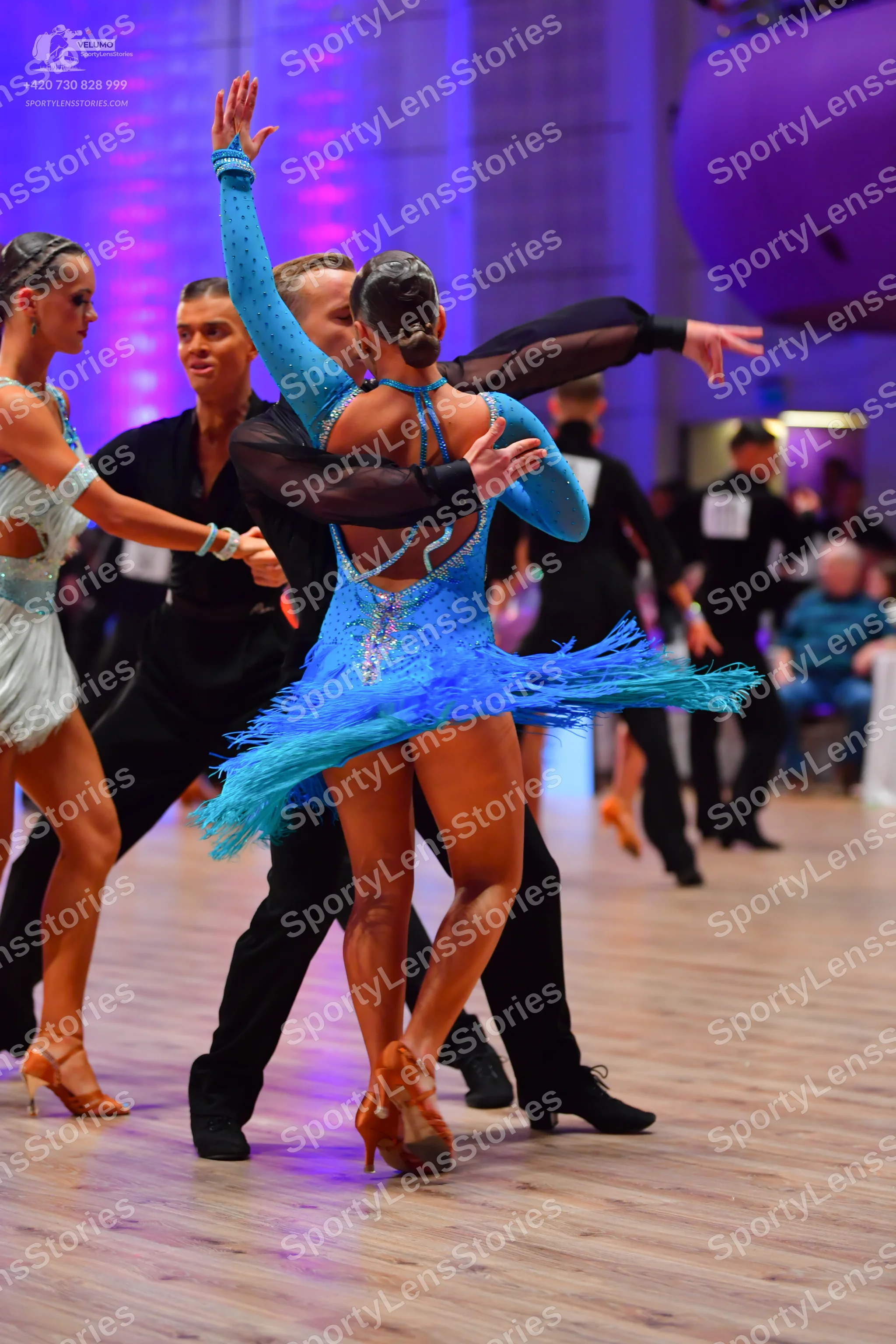 Dancesport competitor: Female dancer 1: light aqua latin dress with lace or sequin details