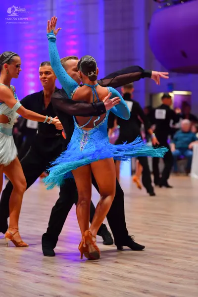 Dancesport competitor: Female dancer 1: light aqua latin dress with lace or sequin details