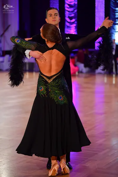 Dancesport competitor: Male dancer: black suit with a white shirt and a white pocket square