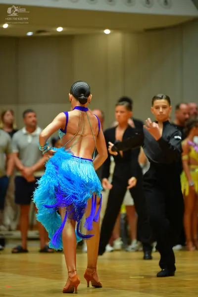 Dancesport competitor: Female dancer: blue and purple latin dance dress with fringe