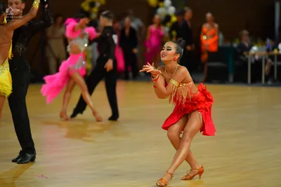 Dancesport competitor: ** Red Latin Dress
*   **Color:** Primarily red with gold accents