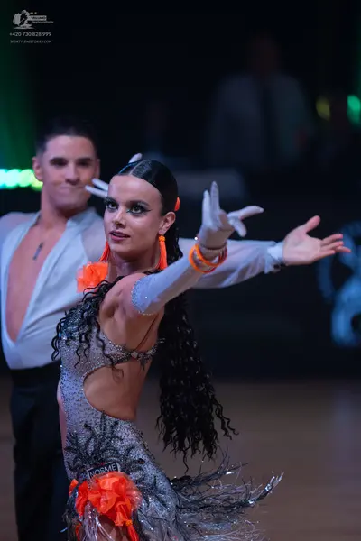 Dancesport competitor: Male dancer: white deep V-neck Latin shirt and black trousers