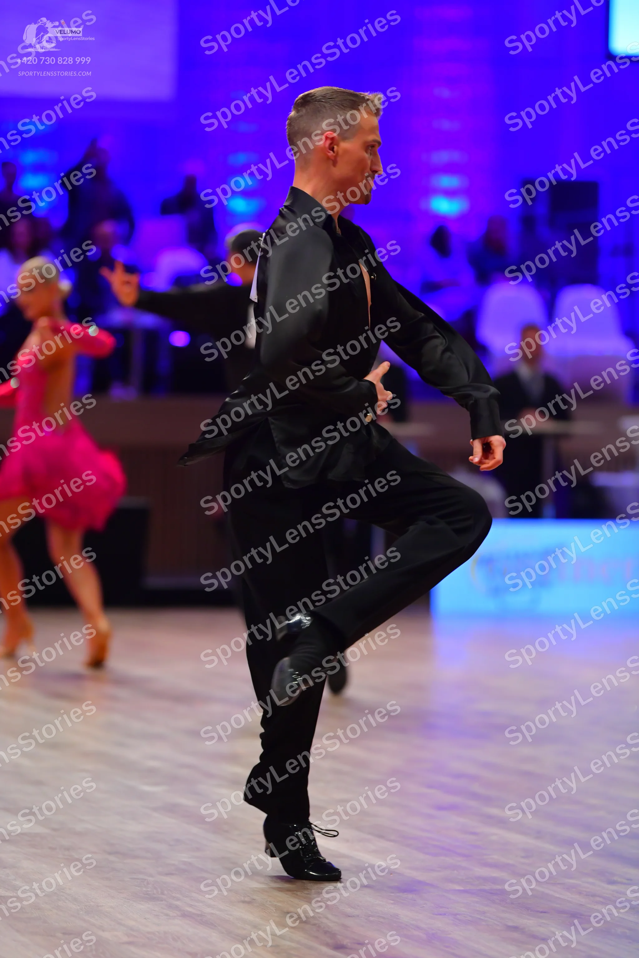 Dancesport competitor: Male dancer: black satin-like long-sleeved shirt and black trousers