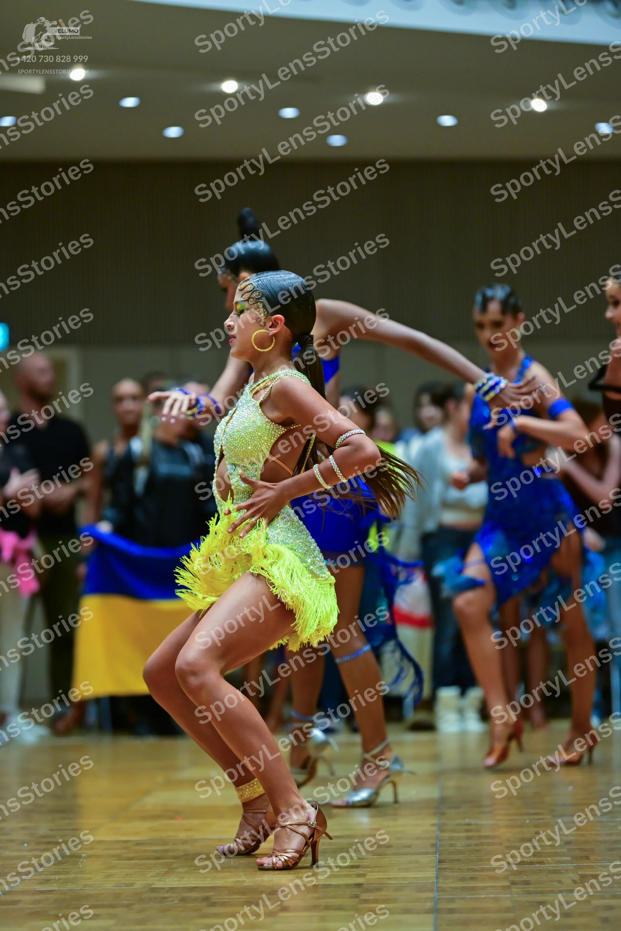 Dancesport competitor: Female dancer 1: lime green/yellow latin dress with sequins and yellow fringe, w
