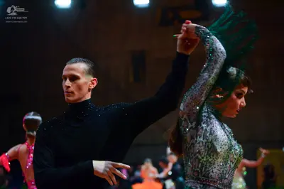 Dancesport competitor: Male dancer: black long-sleeved turtleneck shirt