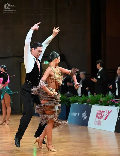 Dancesport competitor: Male dancer: white long-sleeved shirt, black waistcoat, and black trousers