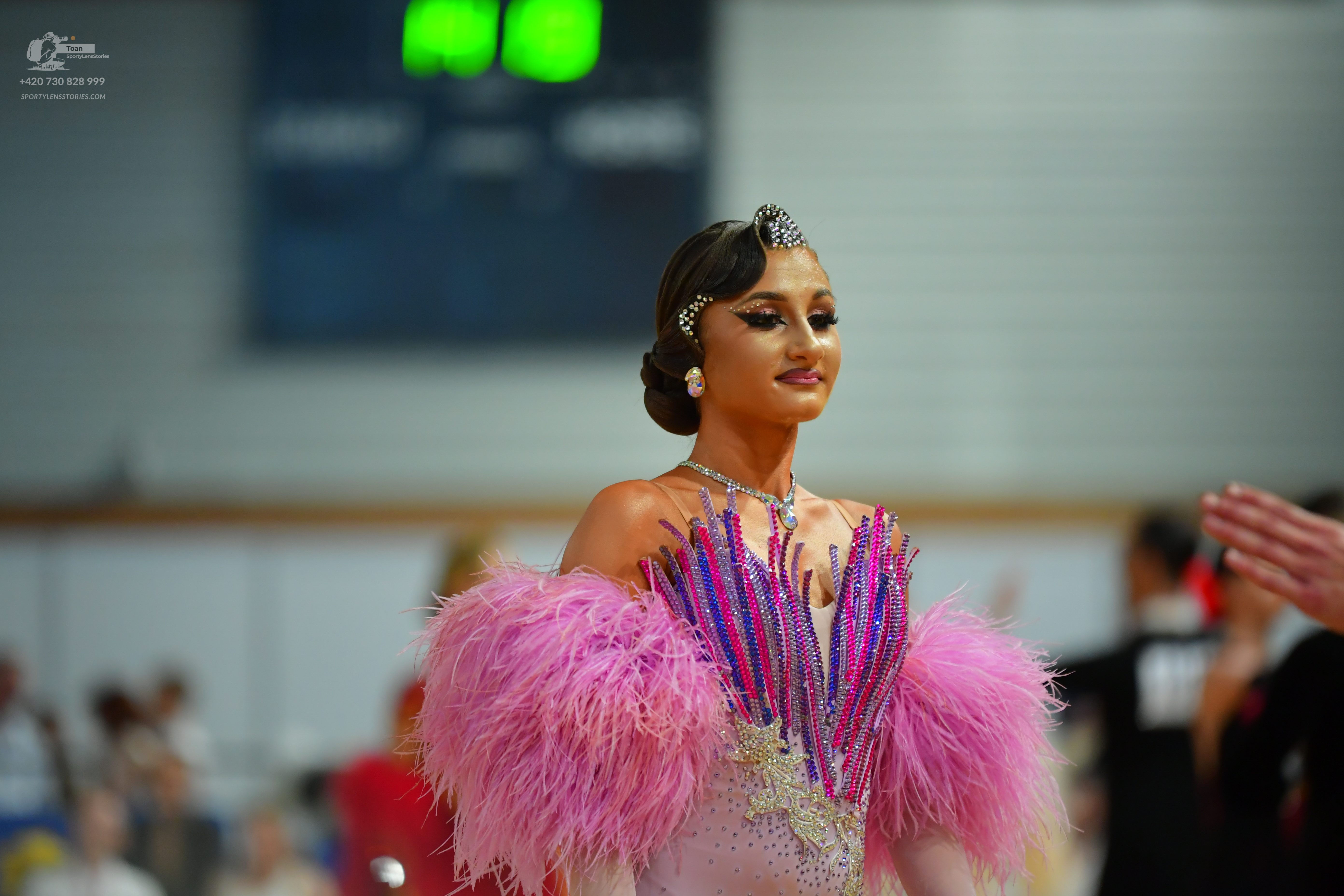 Dancesport competitor: ** Female: pink Latin dress with a dramatic, intricate bodice covered in sparkli