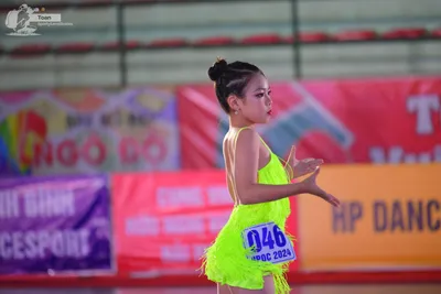 Dancesport competitor: ** Female
*   **Color:** Bright Yellow
*   **Fabric:** Sequin (primarily)
*   **