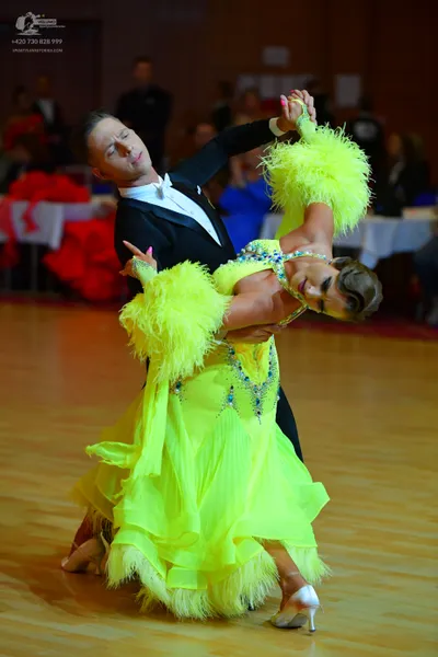 Dancesport competitor: Male dancer: black suit with a white shirt and a white bow tie