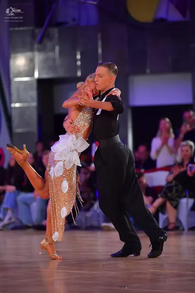 Dancesport competitor: Male dancer: black short-sleeved shirt and black trousers