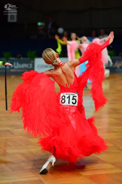 Dancesport competitor #815: Female dancer in foreground: red Latin dress with long red fringe