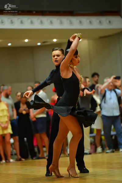 Dancesport competitor: Male dancer: black long-sleeved top and trousers