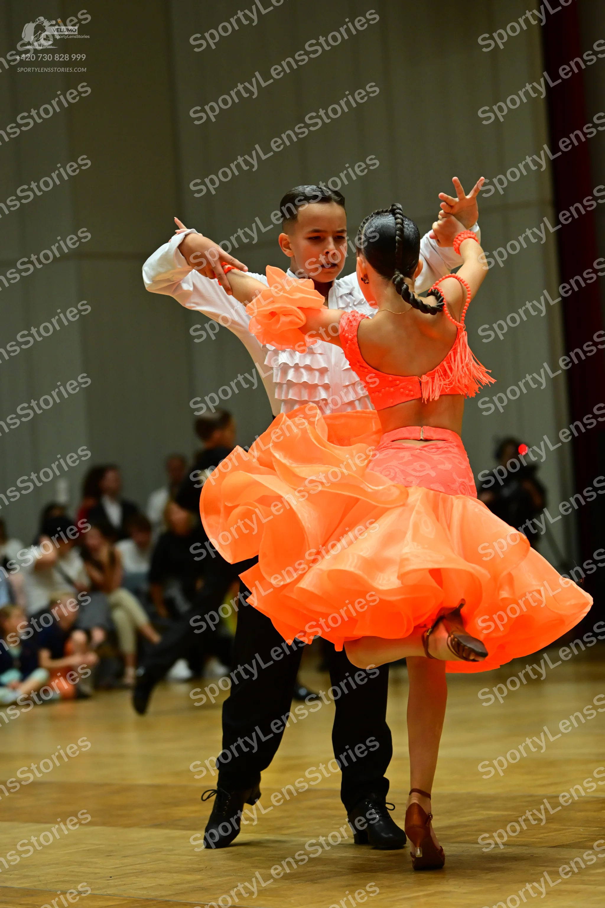 Dancesport competitor: Male dancer: white long-sleeved shirt with ruffles on the front and black trouse