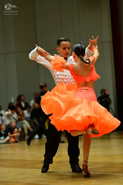Dancesport competitor: Male dancer: white long-sleeved shirt with ruffles on the front and black trouse