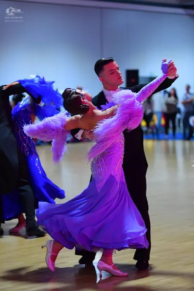 Dancesport competitor: Male dancer: black suit with white shirt and white bow tie