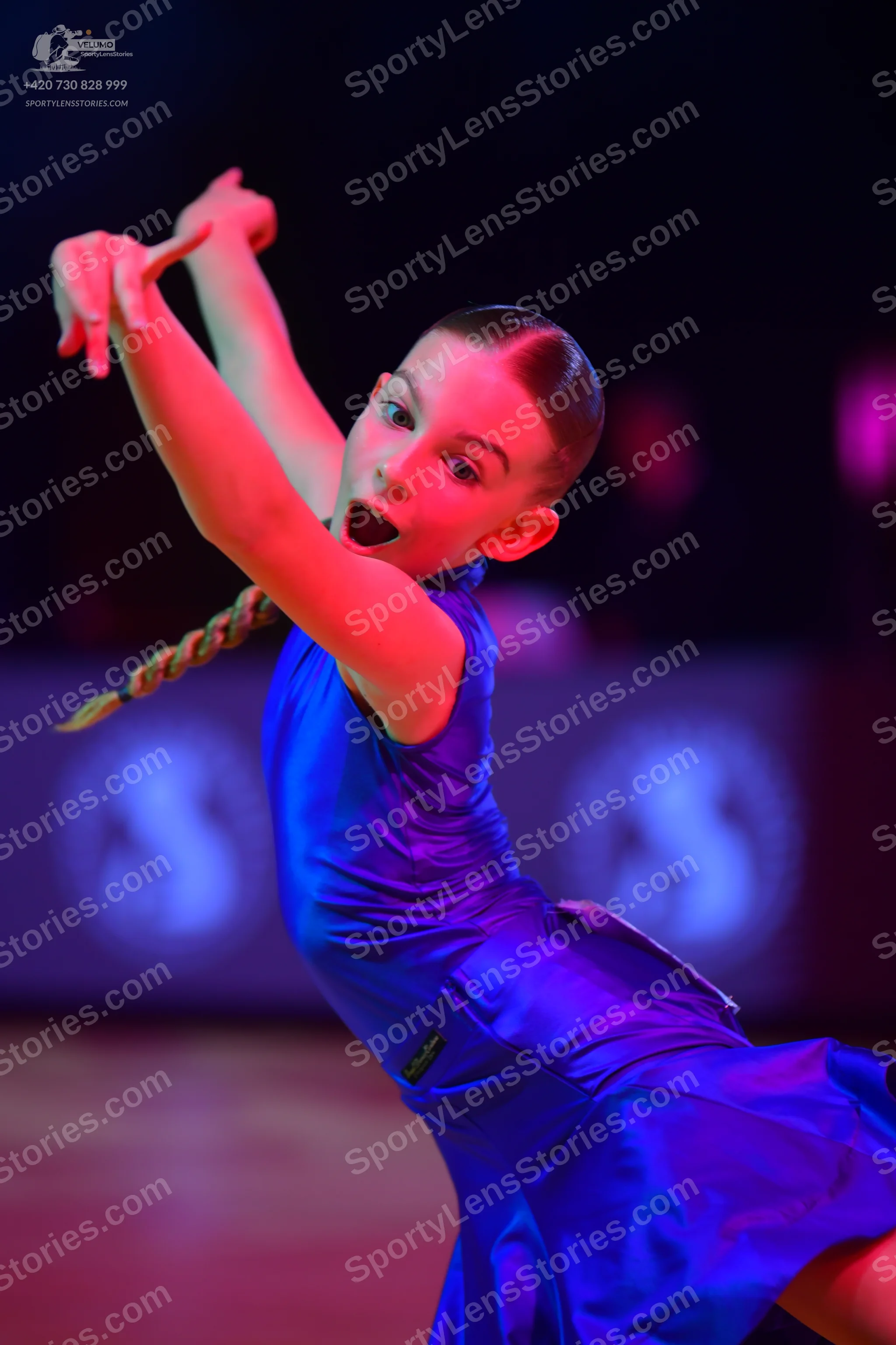 Dancesport competitor: Female dancer: blue satin-like sleeveless latin dress with a flared skirt