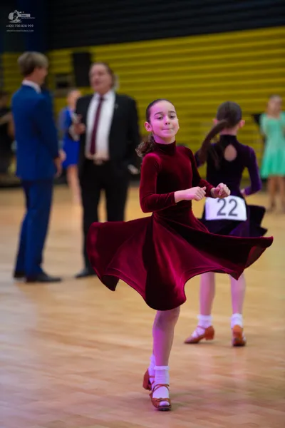 Dancesport competitor #22: ** Red
*   **Fabric:** Velvet
*   **Style:** Latin Dress - A fitted red dress wi