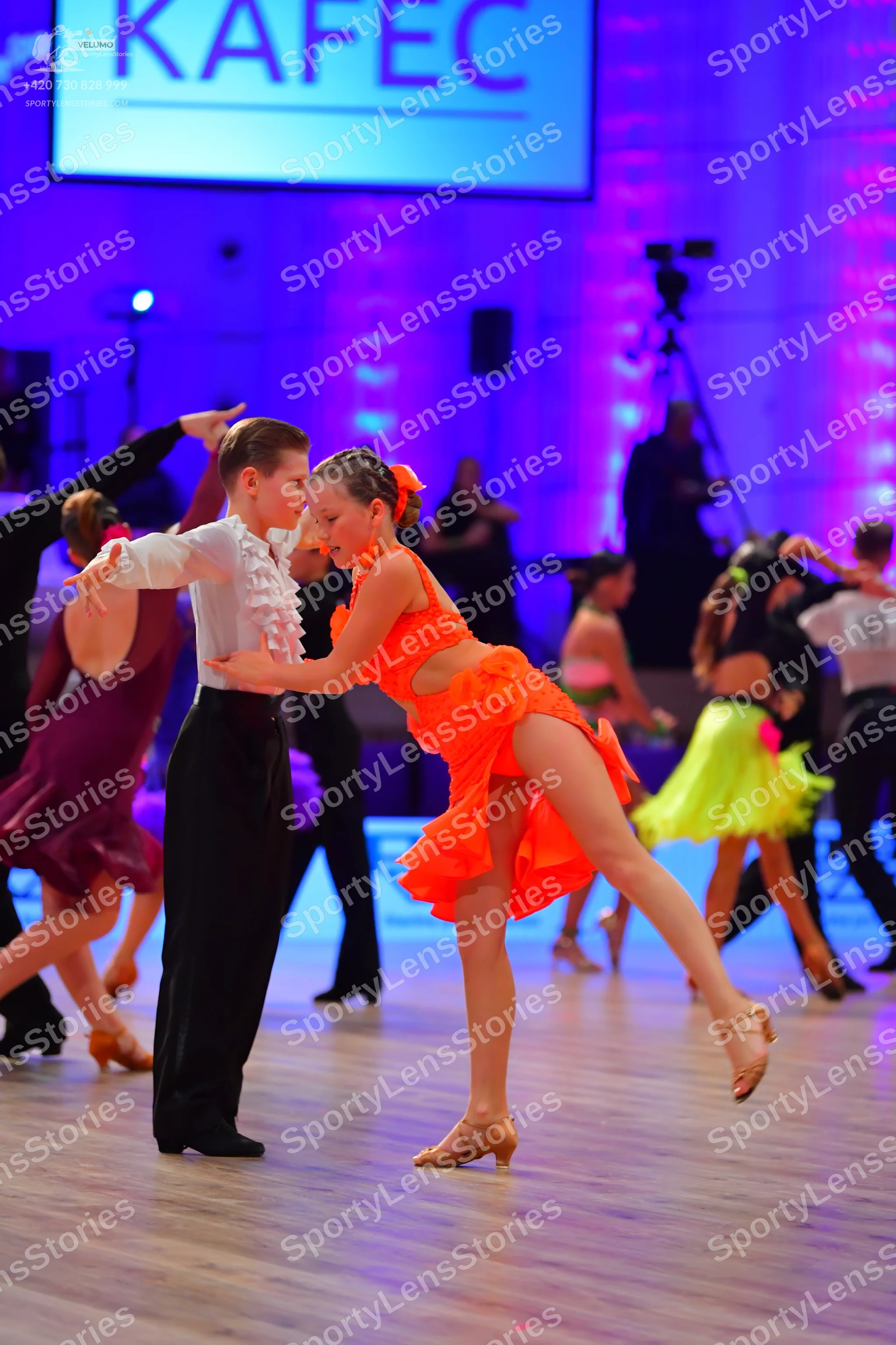 Dancesport competitor: Male dancer: white long-sleeved shirt with ruffles on the chest and black trouse