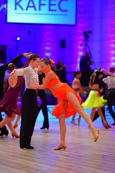 Dancesport competitor: Male dancer: white long-sleeved shirt with ruffles on the chest and black trouse