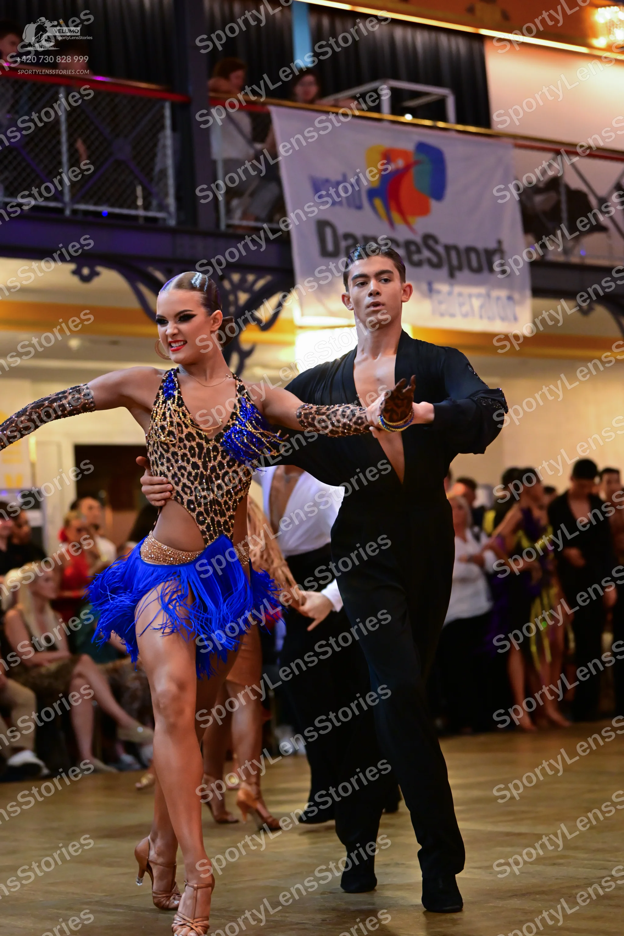 Dancesport competitor: Male dancer: black long-sleeved Latin dance shirt and matching black trousers