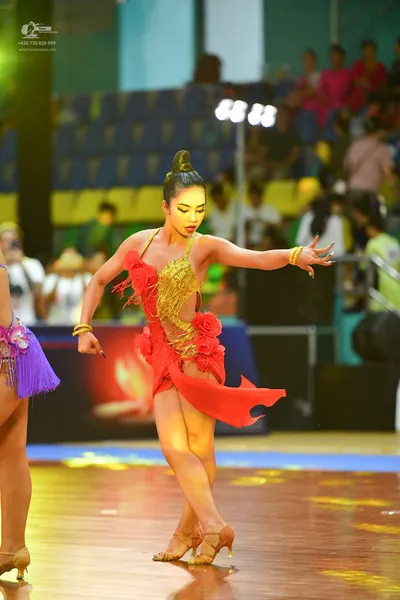 Dancesport competitor: ** Red Latin Dress
*   **Color:** Primarily deep, vibrant red