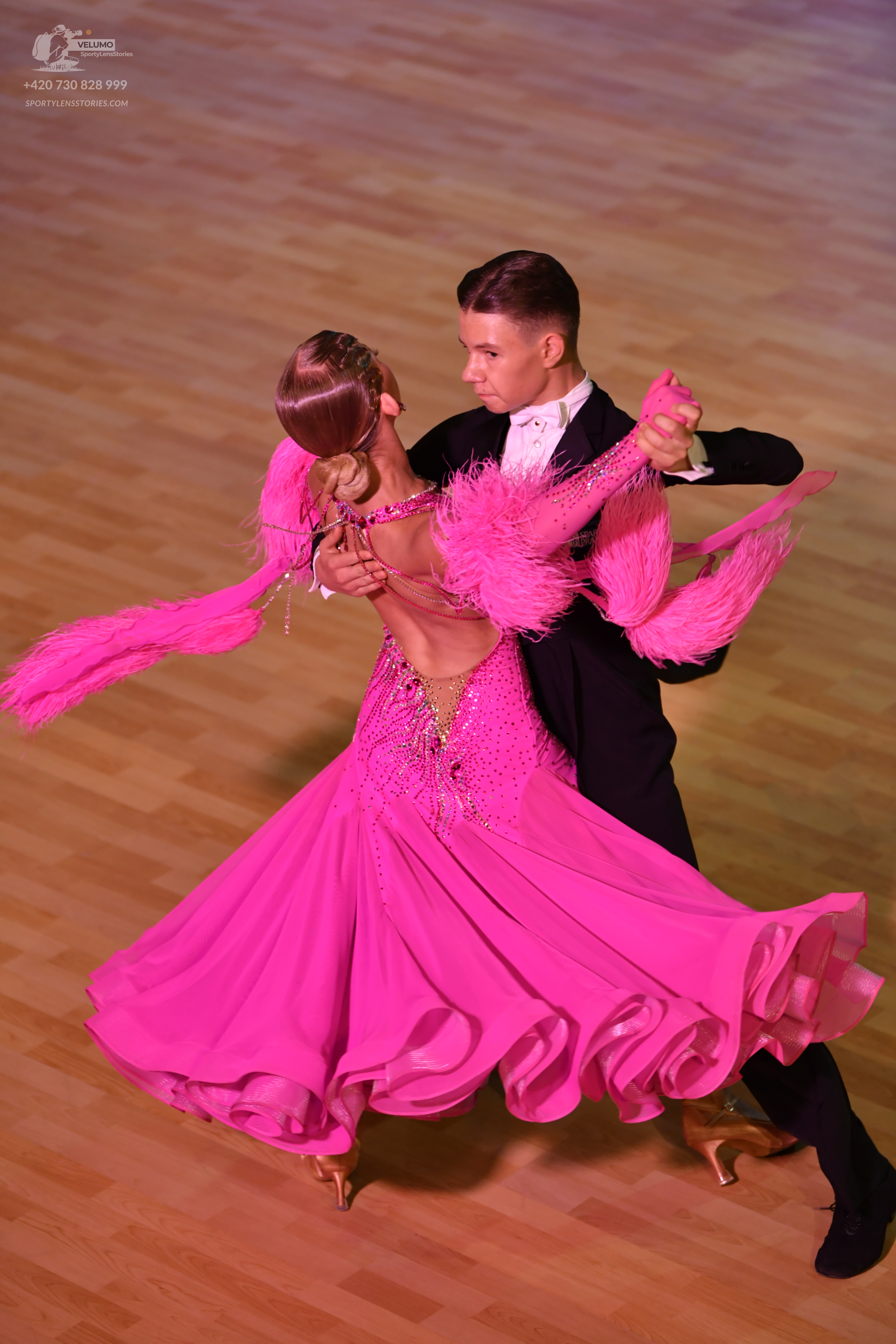 Dancesport competitor: Male:** Black, fitted suit with sequin lapels and a matching black bow tie