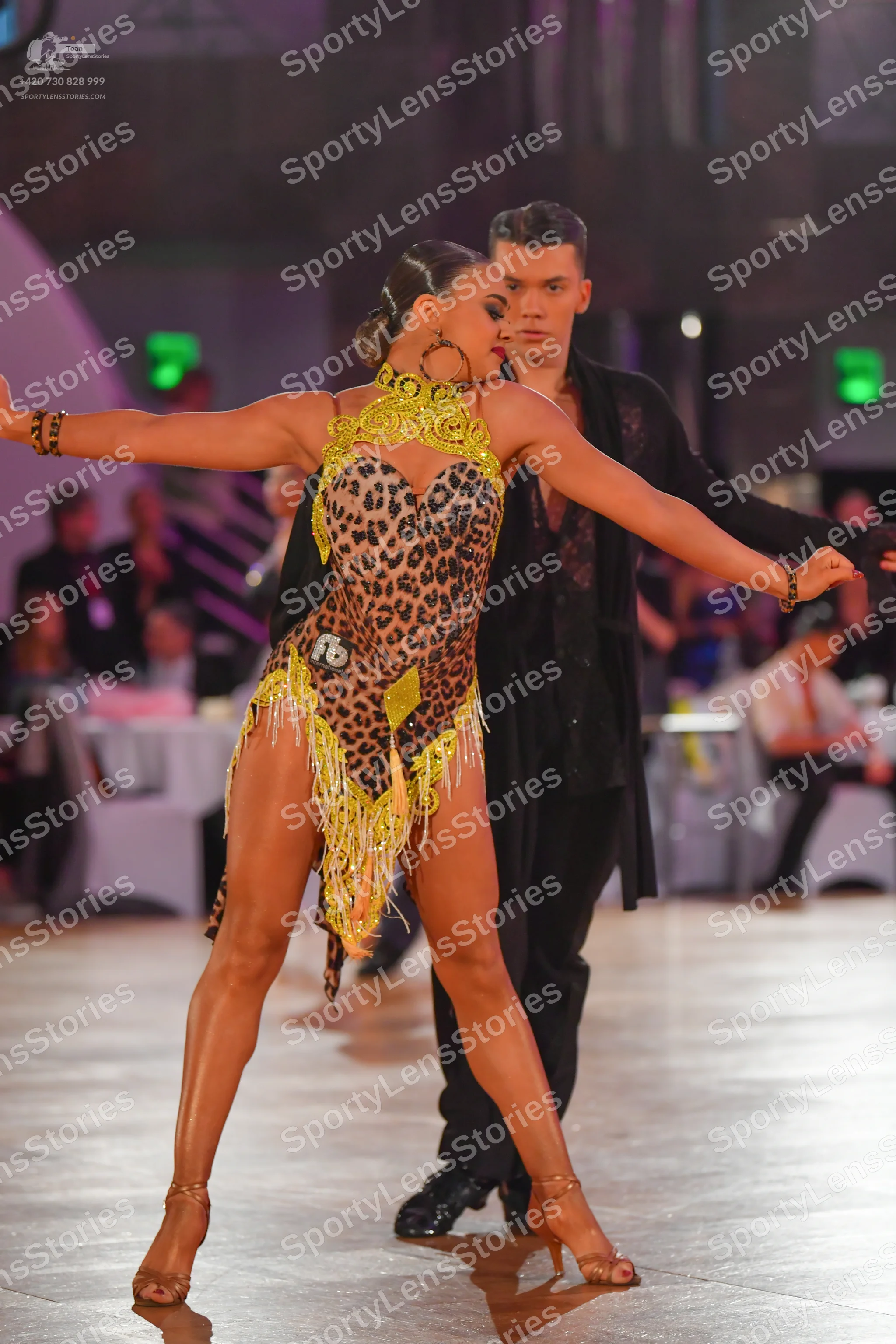 Dancesport competitor: Female dancer: leopard print Latin dance costume with lime green/yellow trim and