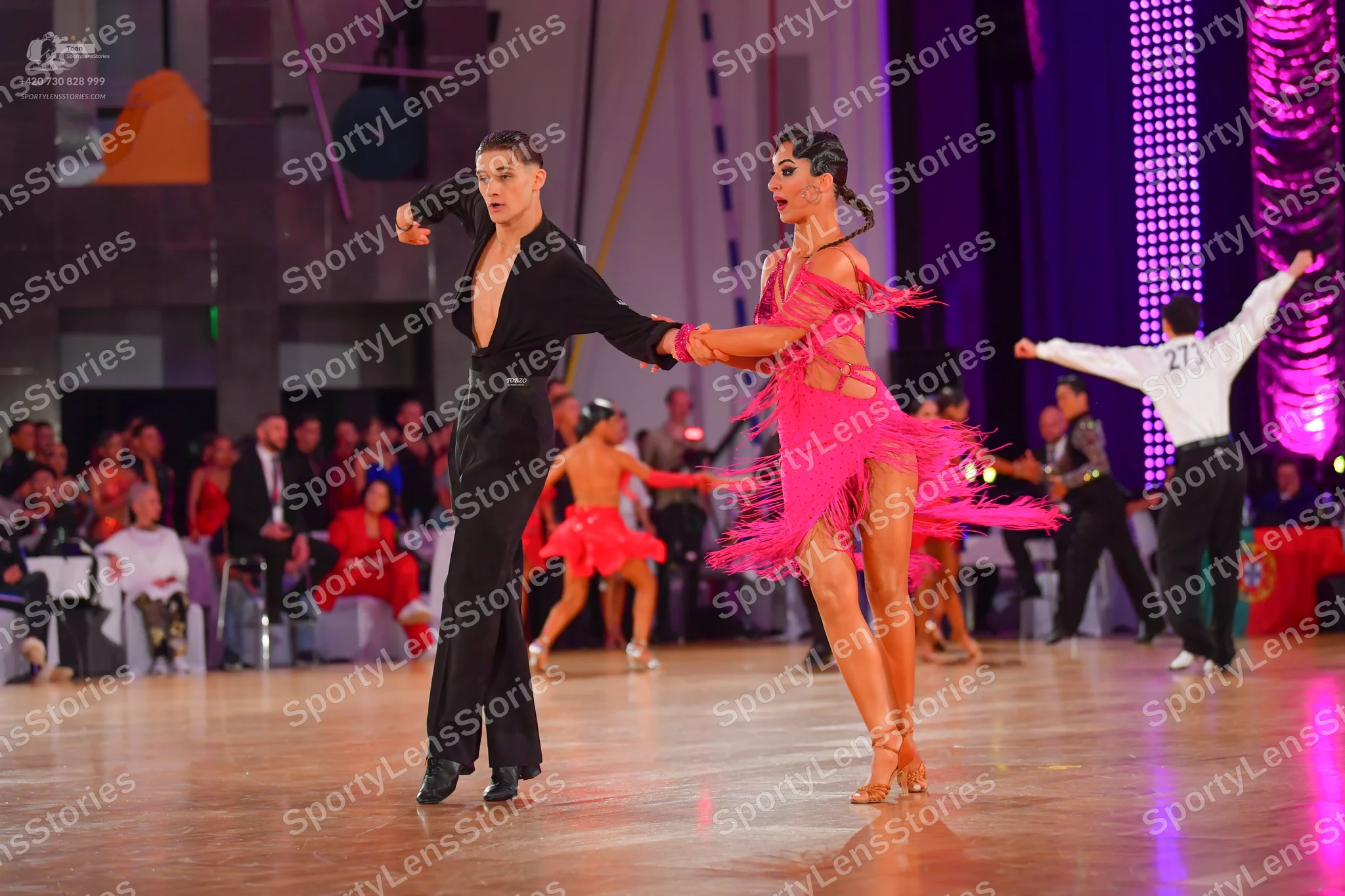 Dancesport competitor #27: Male dancer: black long-sleeved shirt with deep V-neck and black trousers