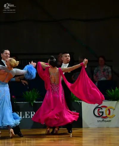 Dancesport competitor: Female dancer 1: light blue ballroom gown with a voluminous skirt and large blue