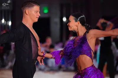 Dancesport competitor: Male dancer: black suit with a sheer mesh panel on the chest